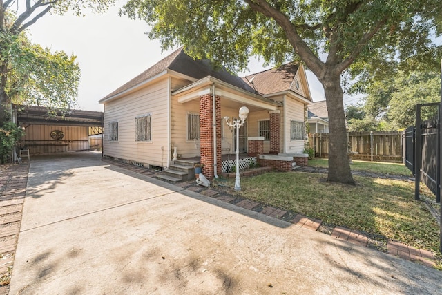 2009 Chestnut St, Houston, TX 77009 - view of front of property featuring driveway, covered porch, roof with shingles, and brick siding