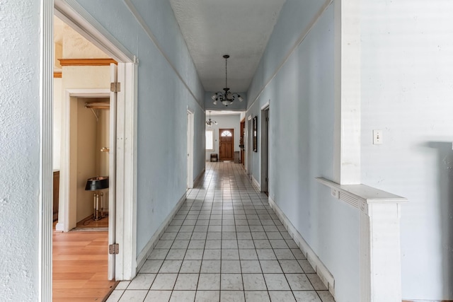 2009 Chestnut St, Houston, TX 77009 - hallway with a chandelier and light tile patterned floors