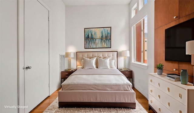 2436 Bissonnet St Unit 8, Houston, TX 77005 - bedroom with multiple windows, light wood-style floors, and baseboards