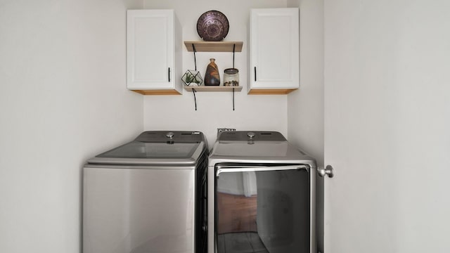 2436 Bissonnet St Unit 8, Houston, TX 77005 - laundry room with cabinet space and washer and dryer