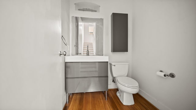 2436 Bissonnet St Unit 8, Houston, TX 77005 - half bath with toilet, wood finished floors, baseboards, and vanity
