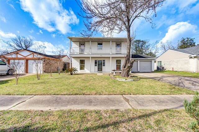 10102 Kirkvale Dr, Houston, TX 77089 - view of front of property with a garage, driveway, a balcony, and covered porch