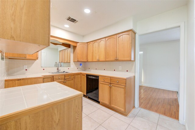 10102 Kirkvale Dr, Houston, TX 77089 - kitchen featuring black dishwasher, tile counters, a sink, backsplash, and recessed lighting