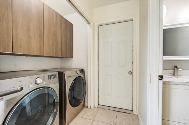 10102 Kirkvale Dr, Houston, TX 77089 - washroom featuring cabinet space, light tile patterned flooring, and washing machine and clothes dryer