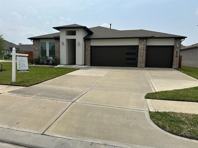 14007 Valley Creek Ct, Conroe, TX 77384 - prairie-style home with an attached garage, concrete driveway, brick siding, and a front yard