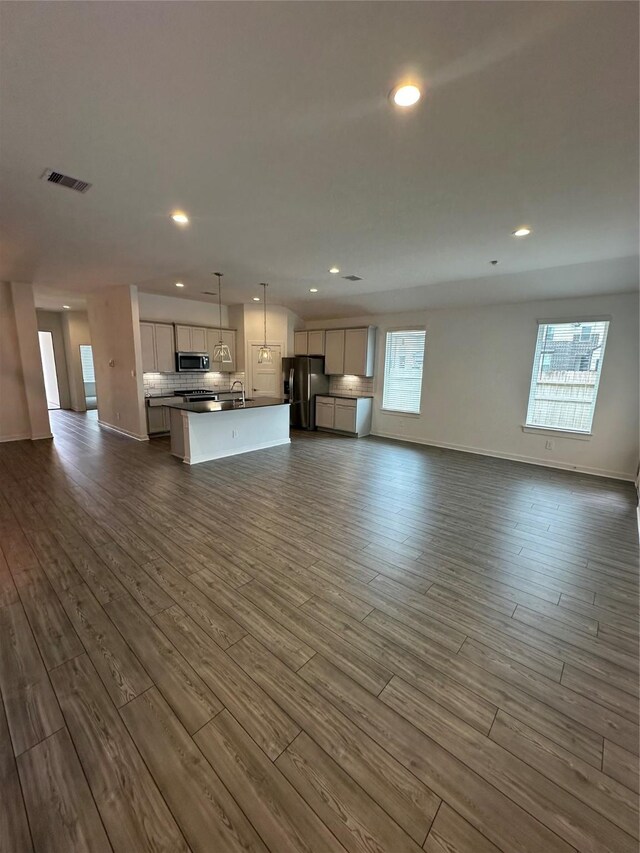 14007 Valley Creek Ct, Conroe, TX 77384 - unfurnished living room with dark wood finished floors, recessed lighting, and healthy amount of natural light
