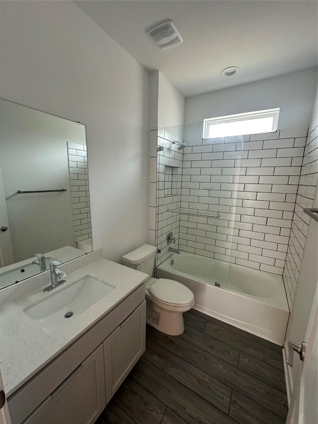 14007 Valley Creek Ct, Conroe, TX 77384 - bathroom with wood finished floors, toilet, shower / bathtub combination, and vanity