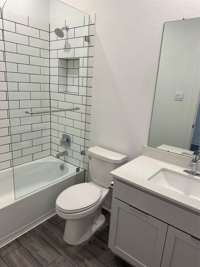 14007 Valley Creek Ct, Conroe, TX 77384 - full bathroom with wood finished floors, toilet, tub / shower combination, and vanity