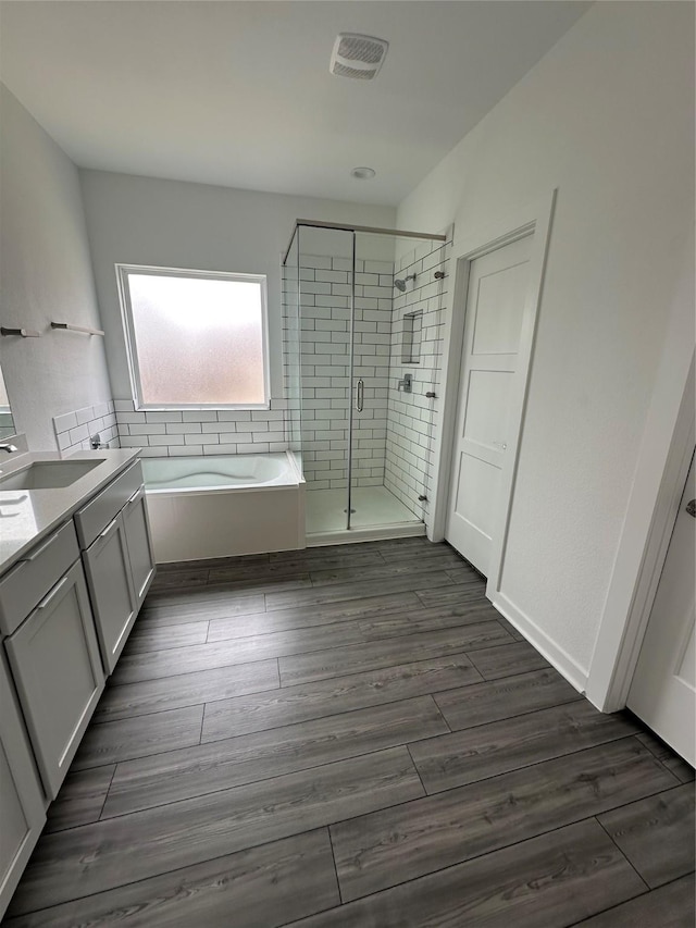 14007 Valley Creek Ct, Conroe, TX 77384 - bathroom featuring a shower stall, a garden tub, vanity, and wood finished floors