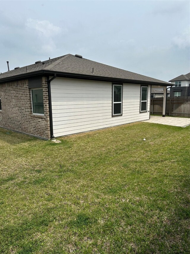 14007 Valley Creek Ct, Conroe, TX 77384 - back of property featuring a patio area, brick siding, and roof with shingles