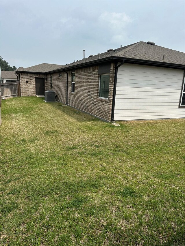 14007 Valley Creek Ct, Conroe, TX 77384 - rear view of house with brick siding and central AC