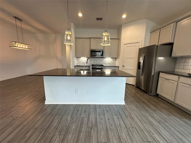 14007 Valley Creek Ct, Conroe, TX 77384 - kitchen featuring appliances with stainless steel finishes, dark countertops, a sink, backsplash, and recessed lighting