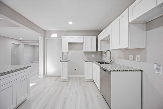 4114 Hoffman St, Houston, TX 77026 - kitchen with a sink, stainless steel dishwasher, light stone counters, white cabinetry, and recessed lighting