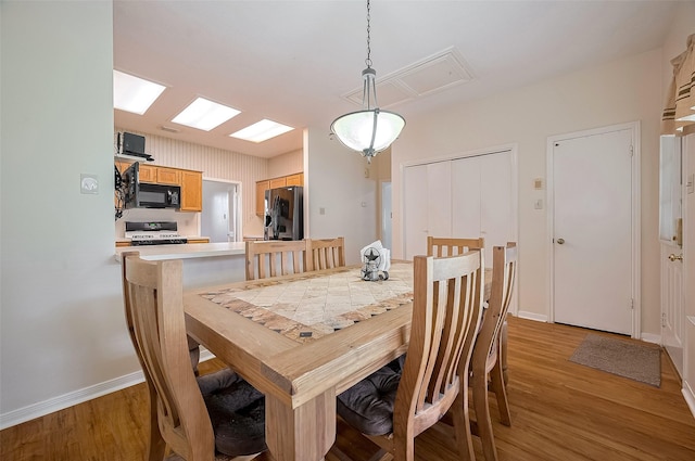 20011 Doherty Cir, Katy, TX 77449 - dining space with light wood-type flooring, baseboards, and attic access