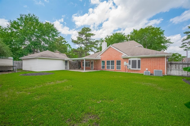 20011 Doherty Cir, Katy, TX 77449 - back of property featuring brick siding, cooling unit, a patio area, and a chimney