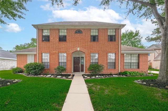 20011 Doherty Cir, Katy, TX 77449 - georgian-style home featuring a front yard, brick siding, and roof with shingles