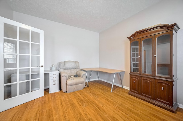 20011 Doherty Cir, Katy, TX 77449 - sitting room with light wood-style floors, baseboards, and a textured ceiling
