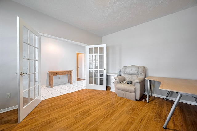 20011 Doherty Cir, Katy, TX 77449 - living area featuring french doors, wood finished floors, and baseboards