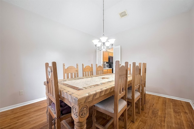 20011 Doherty Cir, Katy, TX 77449 - dining space featuring a chandelier, light wood-style flooring, and baseboards