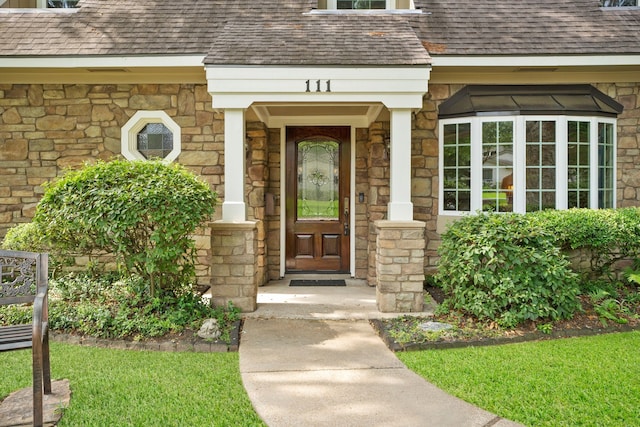 111 Whispering Oaks Dr, Seabrook, TX 77586 - view of exterior entry with stone siding and a shingled roof