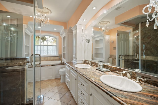 111 Whispering Oaks Dr, Seabrook, TX 77586 - bathroom featuring double vanity, a chandelier, a stall shower, tile patterned flooring, and a garden tub