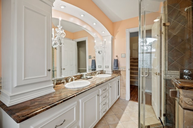 111 Whispering Oaks Dr, Seabrook, TX 77586 - bathroom with a stall shower, double vanity, tile walls, tile patterned flooring, and recessed lighting