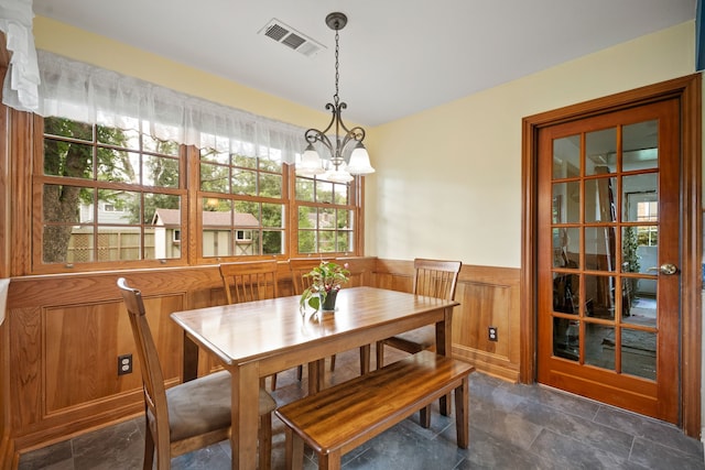 111 Whispering Oaks Dr, Seabrook, TX 77586 - dining area featuring a wainscoted wall, a chandelier, and dark stone finish flooring