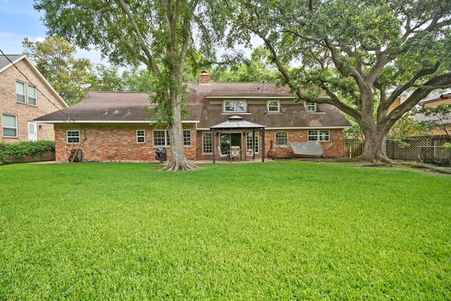 111 Whispering Oaks Dr, Seabrook, TX 77586 - rear view of house with a gazebo, a chimney, roof with shingles, and brick siding