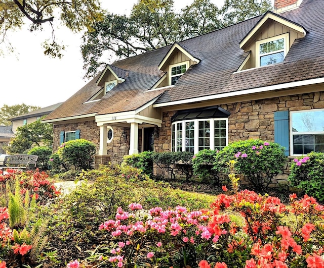 111 Whispering Oaks Dr, Seabrook, TX 77586 - view of front of property featuring stone siding, board and batten siding, and a chimney