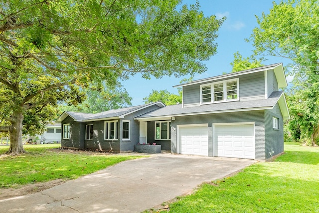 411 Southern Oaks Dr, Lake Jackson, TX 77566 - view of front of home with concrete driveway, a front lawn, a garage, and brick siding