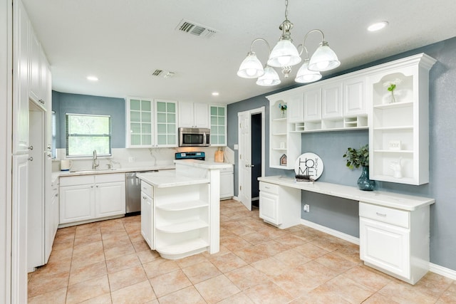 411 Southern Oaks Dr, Lake Jackson, TX 77566 - kitchen with open shelves, stainless steel appliances, a sink, white cabinets, and light countertops