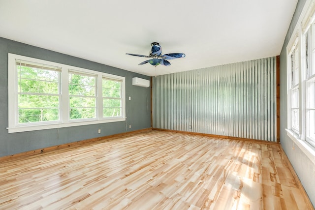411 Southern Oaks Dr, Lake Jackson, TX 77566 - spare room with healthy amount of natural light, a ceiling fan, wood finished floors, and an AC wall unit