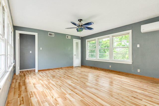 411 Southern Oaks Dr, Lake Jackson, TX 77566 - spare room with a wall unit AC, a ceiling fan, light wood-style floors, and baseboards