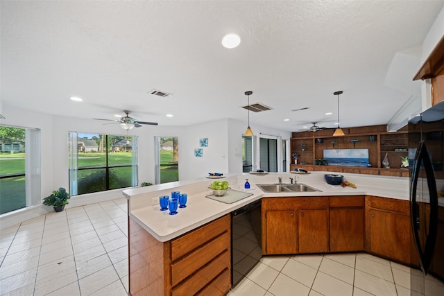 152 April Wind Ct, Montgomery, TX 77356 - kitchen with black dishwasher, a sink, a ceiling fan, light countertops, and open floor plan