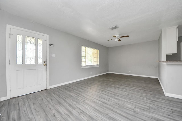 141 E Twickenham Trl, Houston, TX 77076 - foyer featuring a ceiling fan, baseboards, wood finished floors, and a textured ceiling