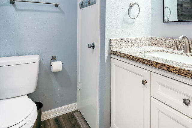 17626 Heritage Creek Dr, Webster, TX 77598 - half bath featuring toilet, vanity, wood finished floors, and baseboards