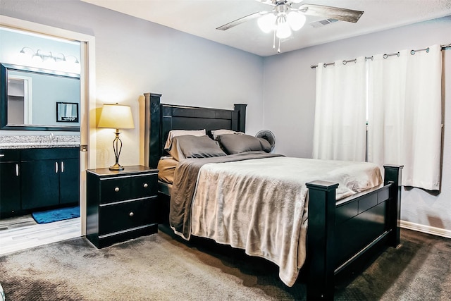 17626 Heritage Creek Dr, Webster, TX 77598 - carpeted bedroom featuring a ceiling fan, connected bathroom, and baseboards