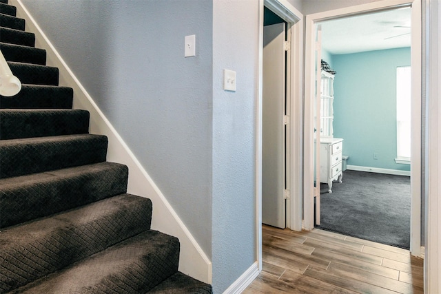 17626 Heritage Creek Dr, Webster, TX 77598 - stairs featuring wood finished floors, baseboards, and a textured wall