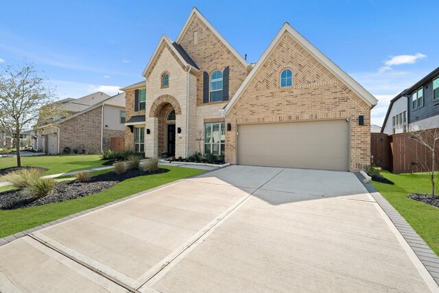 24407 Green Buffalograss Trl, Katy, TX 77493 - view of front of house featuring brick siding, concrete driveway, a front lawn, and an attached garage