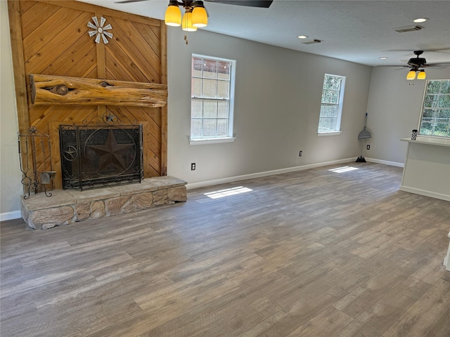 10 Walnut Loop, Shepherd, TX 77371 - unfurnished living room featuring a ceiling fan, baseboards, wood finished floors, a fireplace, and recessed lighting