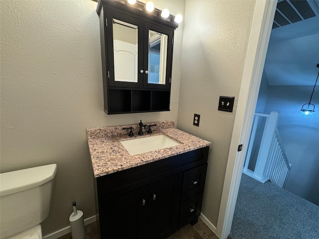 10 Walnut Loop, Shepherd, TX 77371 - half bathroom featuring toilet, vanity, and baseboards