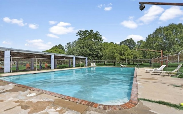 10 Walnut Loop, Shepherd, TX 77371 - community pool featuring a patio area and view of wooded area