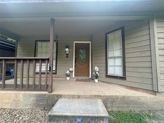 10 Walnut Loop, Shepherd, TX 77371 - doorway to property featuring covered porch