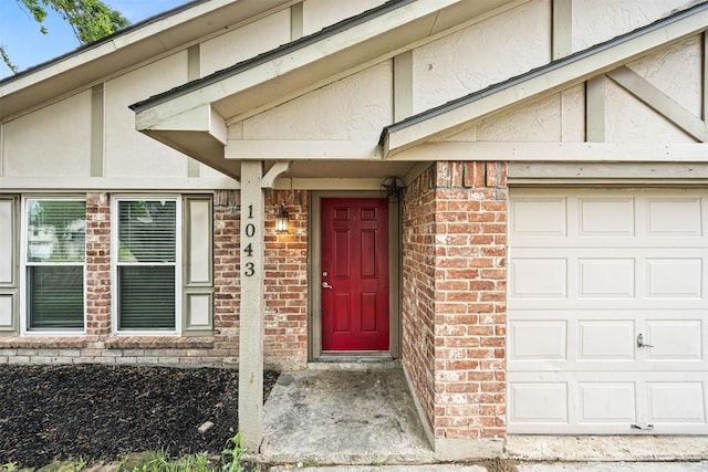 1043 Sierra Shadows Dr, Katy, TX 77450 - view of exterior entry with a garage and brick siding