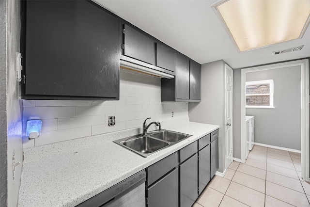 1043 Sierra Shadows Dr, Katy, TX 77450 - kitchen with a sink, light tile patterned floors, light countertops, washer and dryer, and baseboards