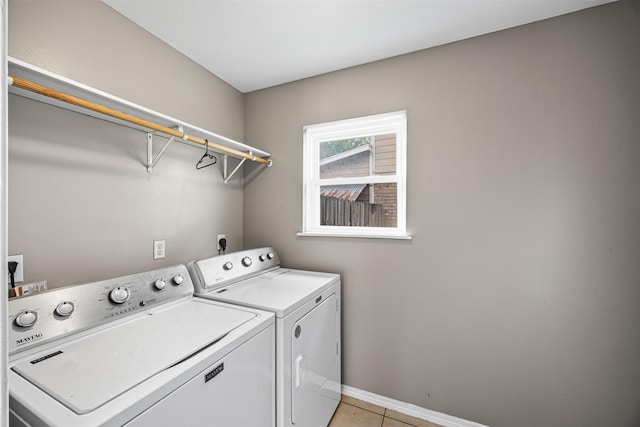 1043 Sierra Shadows Dr, Katy, TX 77450 - washroom featuring washing machine and clothes dryer, light tile patterned floors, and baseboards