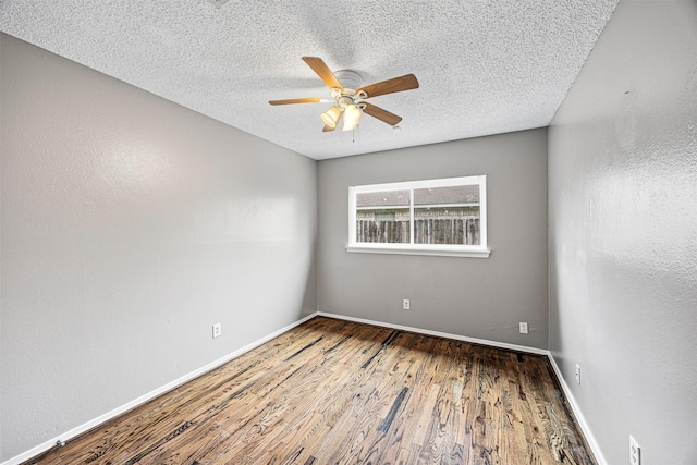1043 Sierra Shadows Dr, Katy, TX 77450 - spare room featuring wood finished floors, a ceiling fan, a textured ceiling, and baseboards
