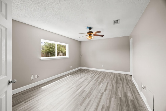 1043 Sierra Shadows Dr, Katy, TX 77450 - empty room featuring a ceiling fan, light wood-style flooring, baseboards, and a textured ceiling