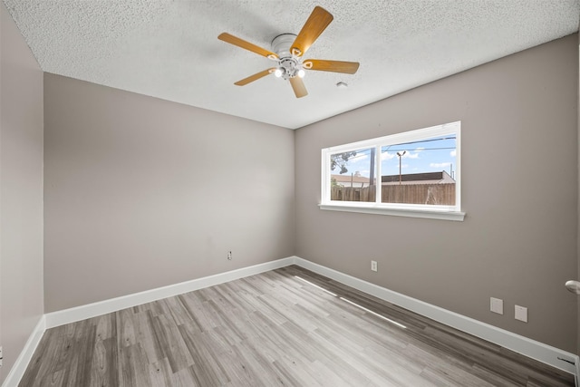 1043 Sierra Shadows Dr, Katy, TX 77450 - unfurnished room with wood finished floors, ceiling fan, baseboards, and a textured ceiling