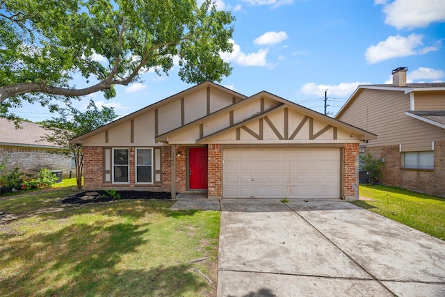 1043 Sierra Shadows Dr, Katy, TX 77450 - tudor house with a garage, a front lawn, driveway, and brick siding